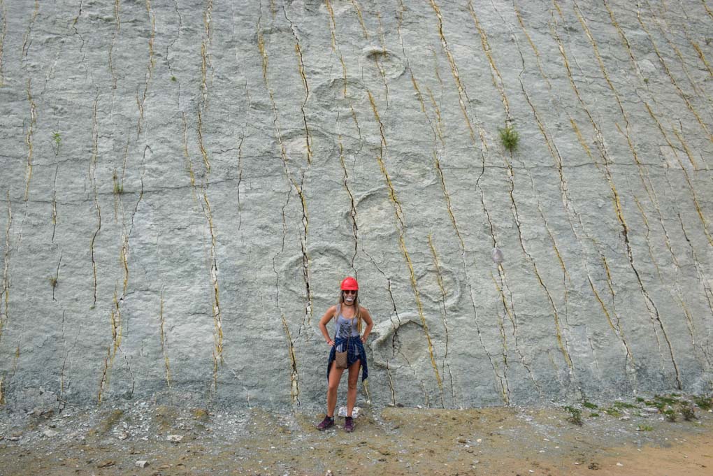 Bailey stands next to the Cal Orck'o dinosaur footprints in Sucre