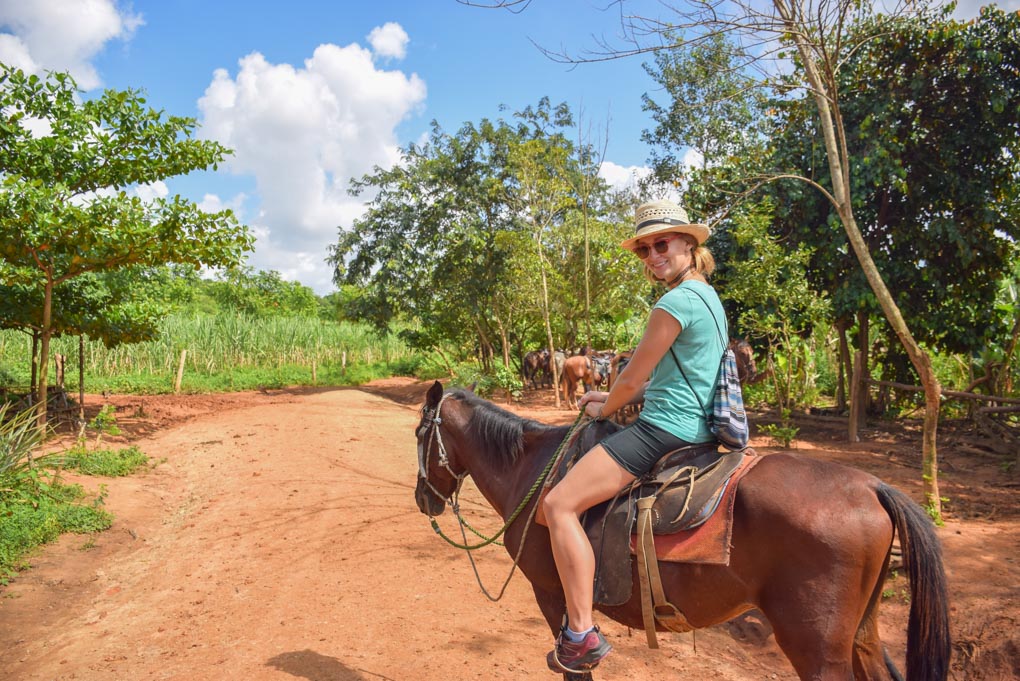 Bailey riding a horse in Vinales, Cuba