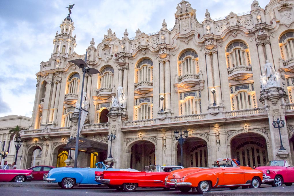 A group of cars used to tour tourists around sit empty in downtown Havana, Cuba