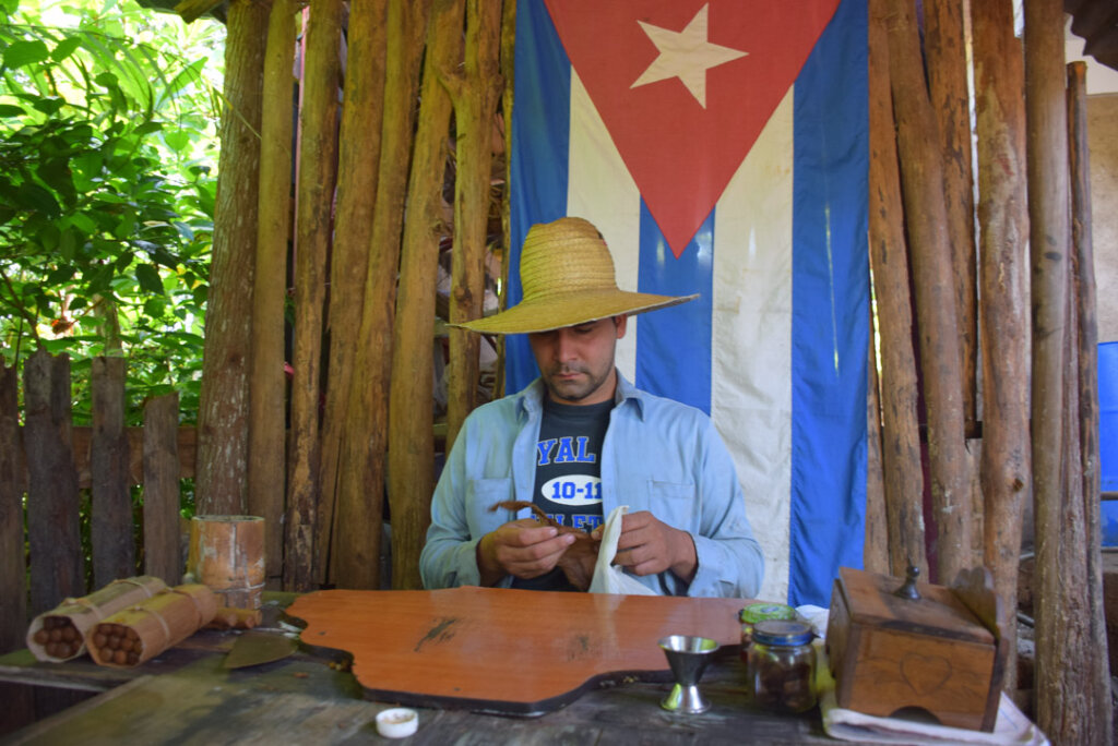 a man in cuba demonstrating how to make real cuban cigars