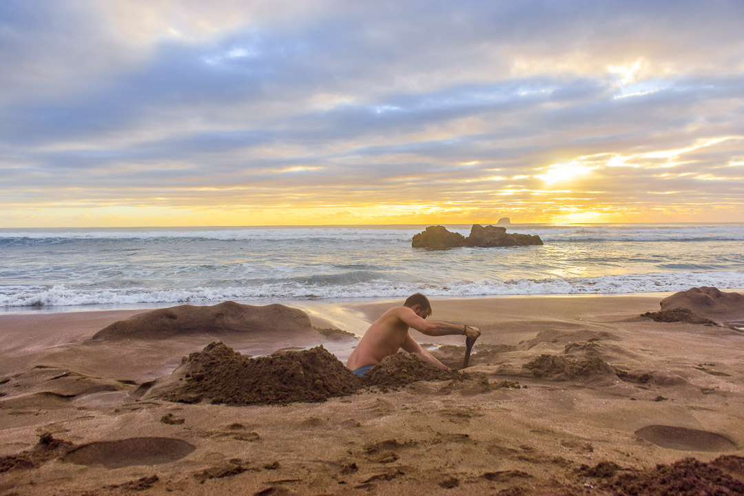 Digging a hole on Hot Water Beach, New Zealand