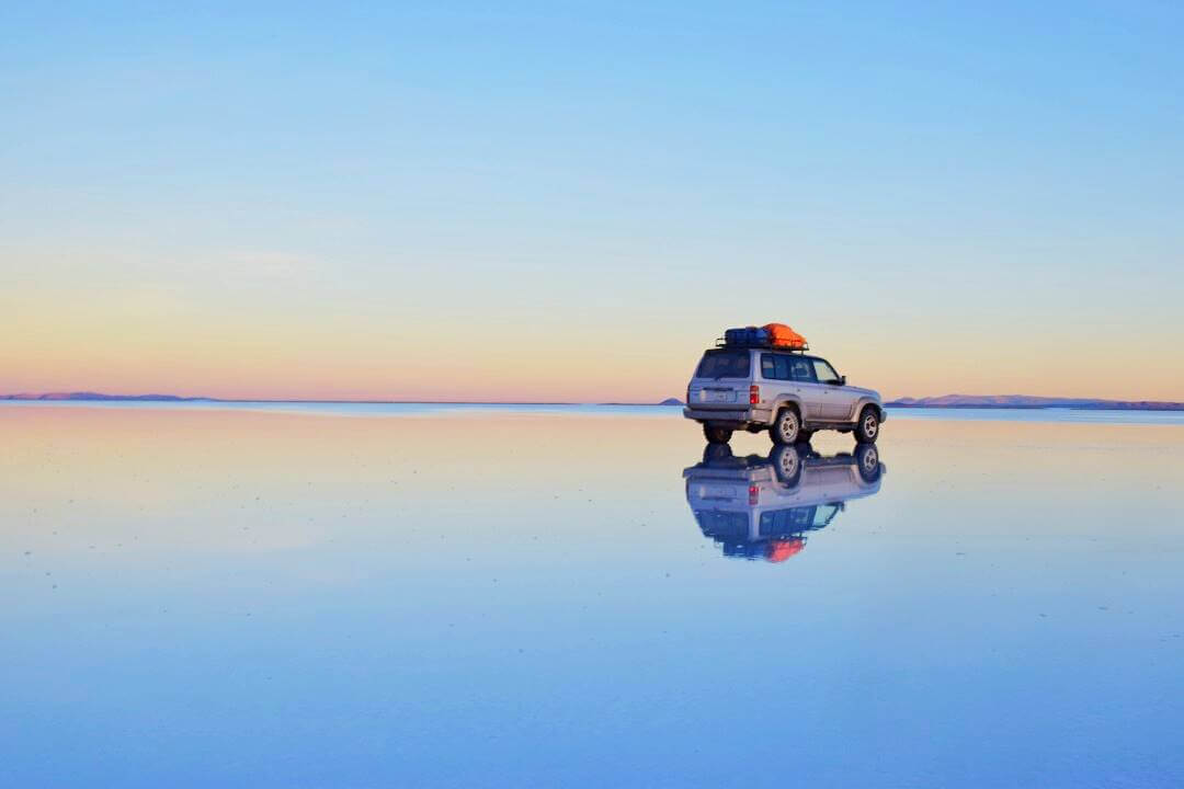 car on the salt flats in bolivia