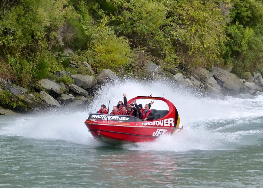 A Shotover Jet speeds through the Shotover River near Queenstown