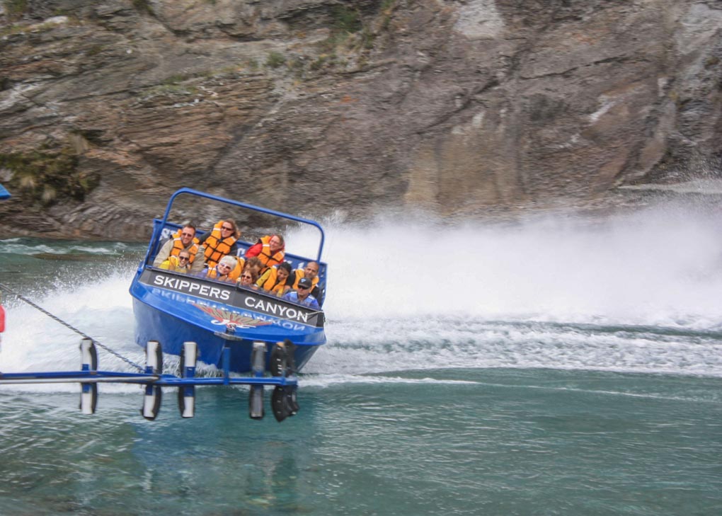 A Skipper Canyon jet boat speeds through the Skippers Canyon near Queenstown