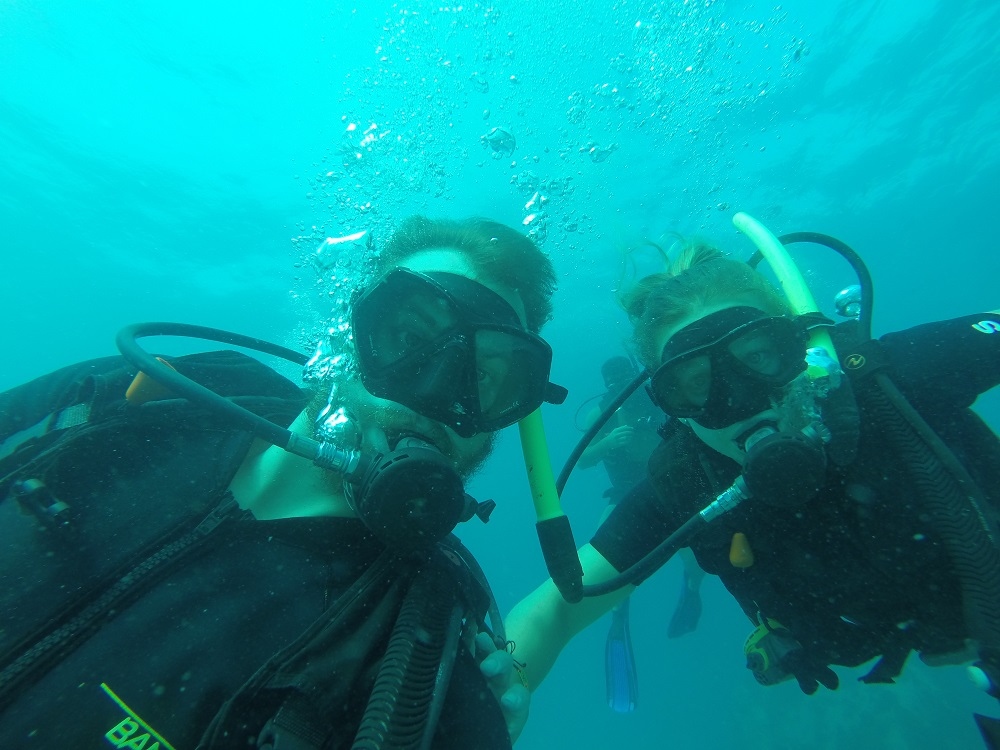 daniel and bailey taking a selfie while scuba diving