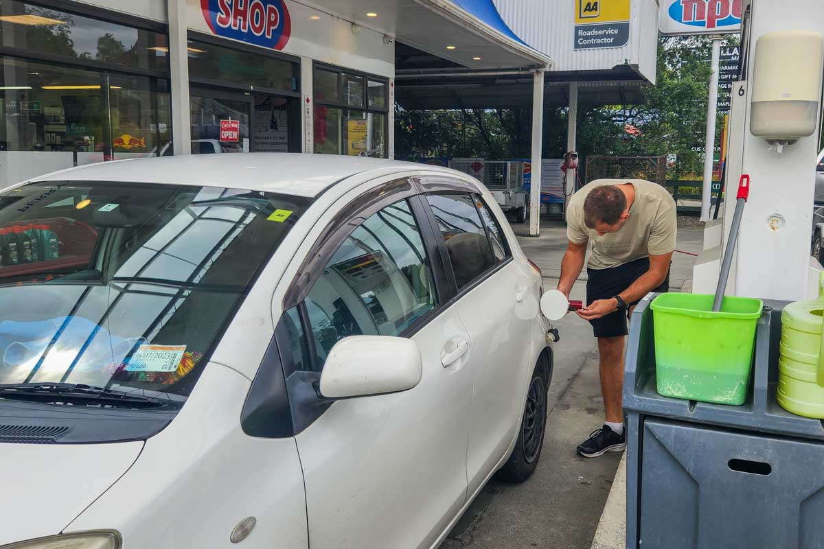 A man fuels up a rental vehicle in New Zealand