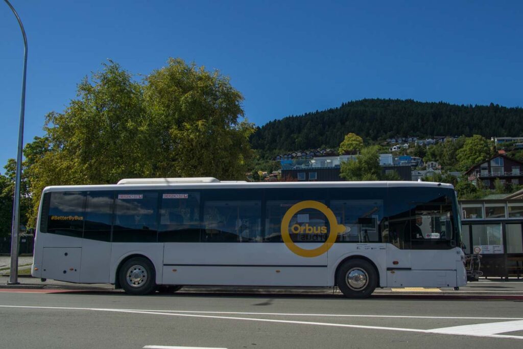the bus driving down the road in Queenstown, New Zealand