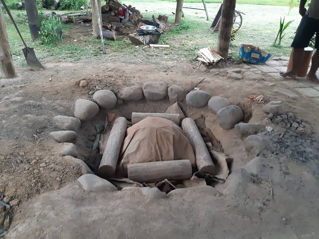the lovo meal cooking in the earth oven at the Fiji Culture Village