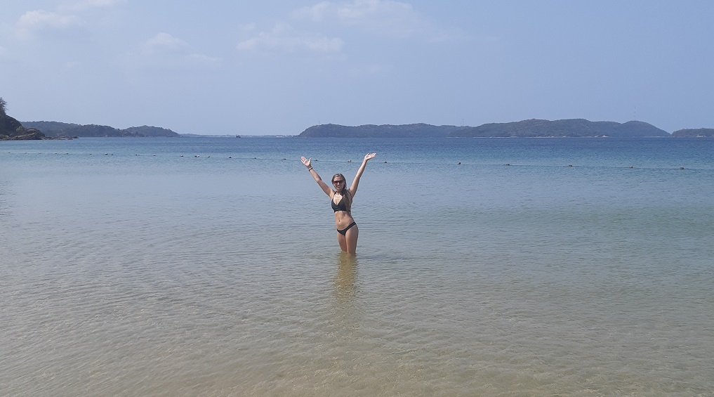 standing in the water at Marble Beach near Trincomalee, Sri Lanka