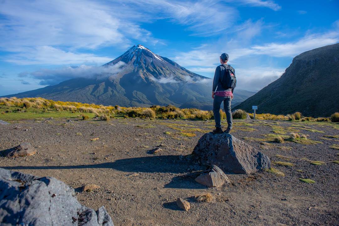 standing on a rock with a view of Mt Taranaki