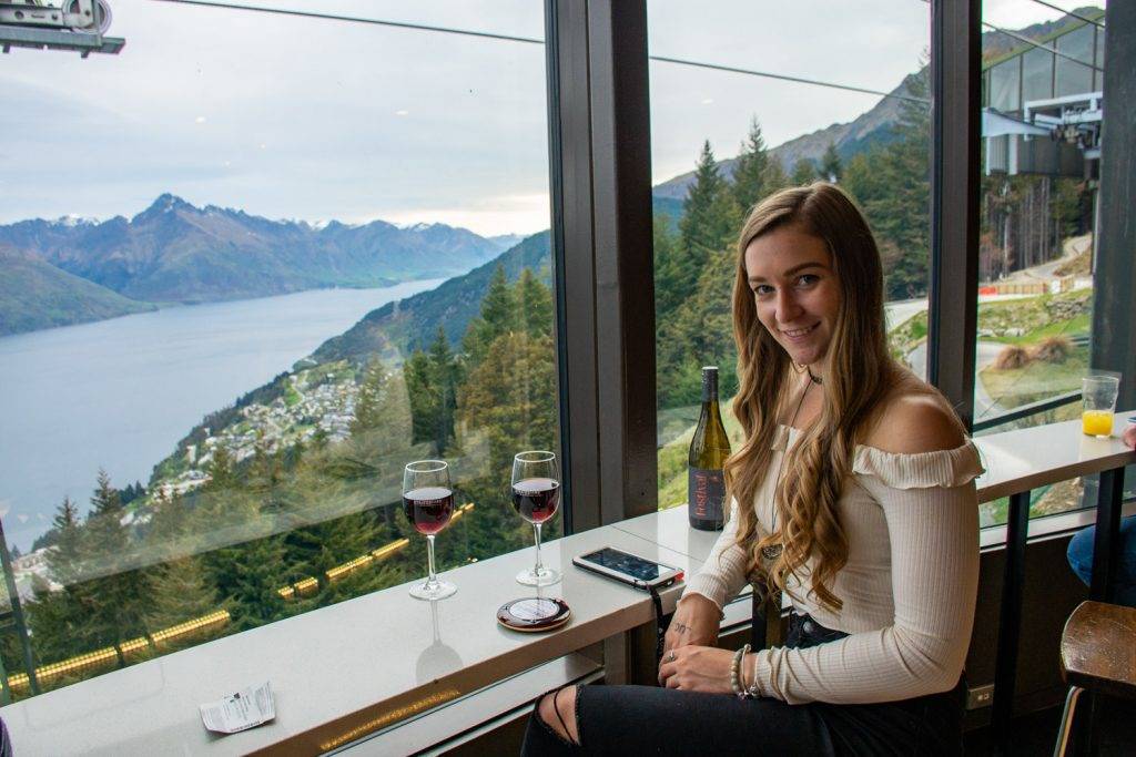 woman at a restaurant overlooking queenstown