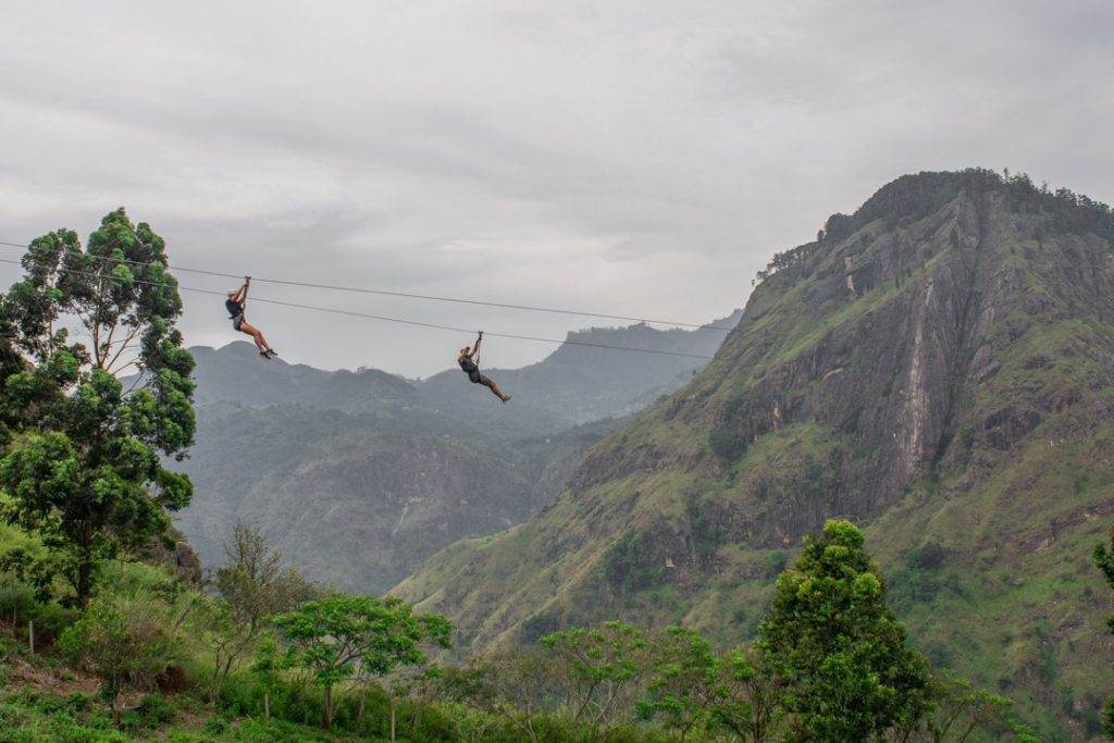 2 people  riding on the Ravana Zipline