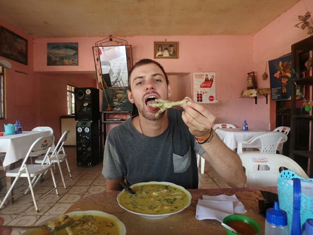 Daniel eats chicken feet soup in Bolivia