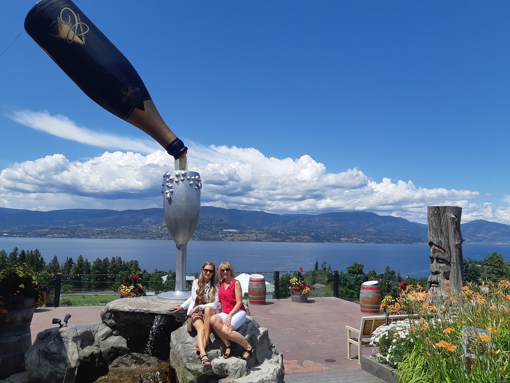 at a winery in kelowna with a view and huge wine bottle