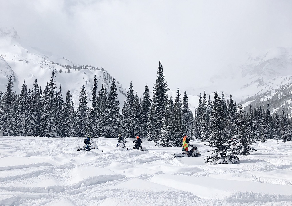 a group of smowmobilers in whistler, canada