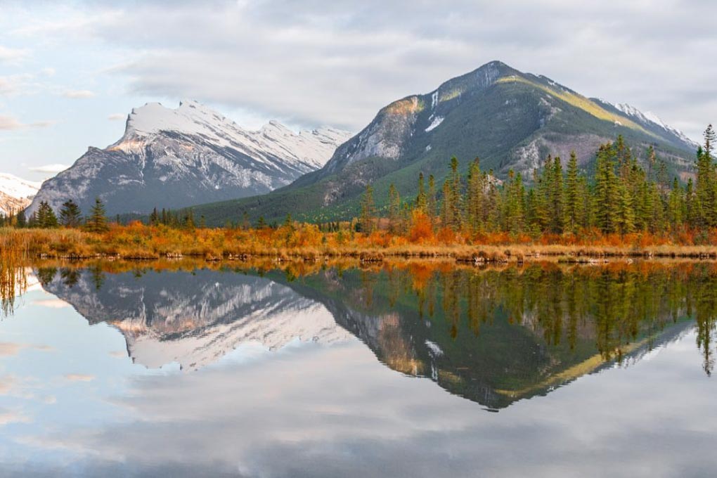The mountains reflect off Vermilion Lakes at sunset