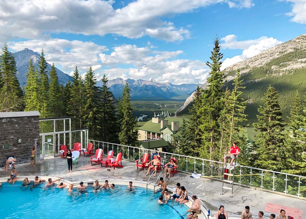 The Banff Upper Hot Springs on a sunny day with the mountains in the background