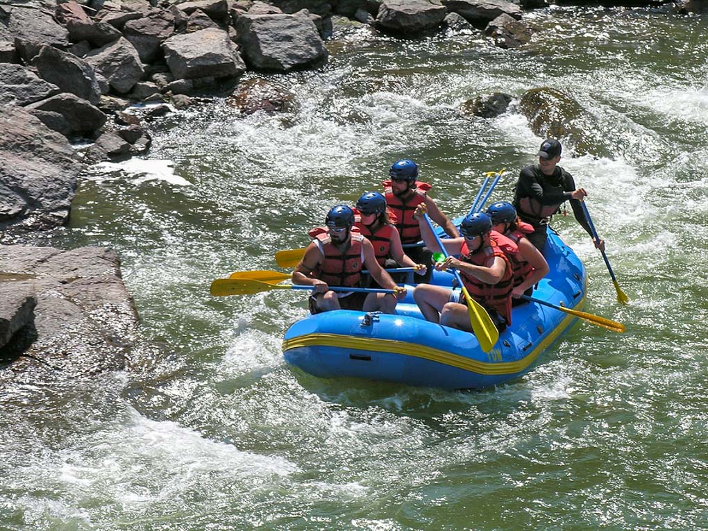 Group Of Friends White Water Rafting.
