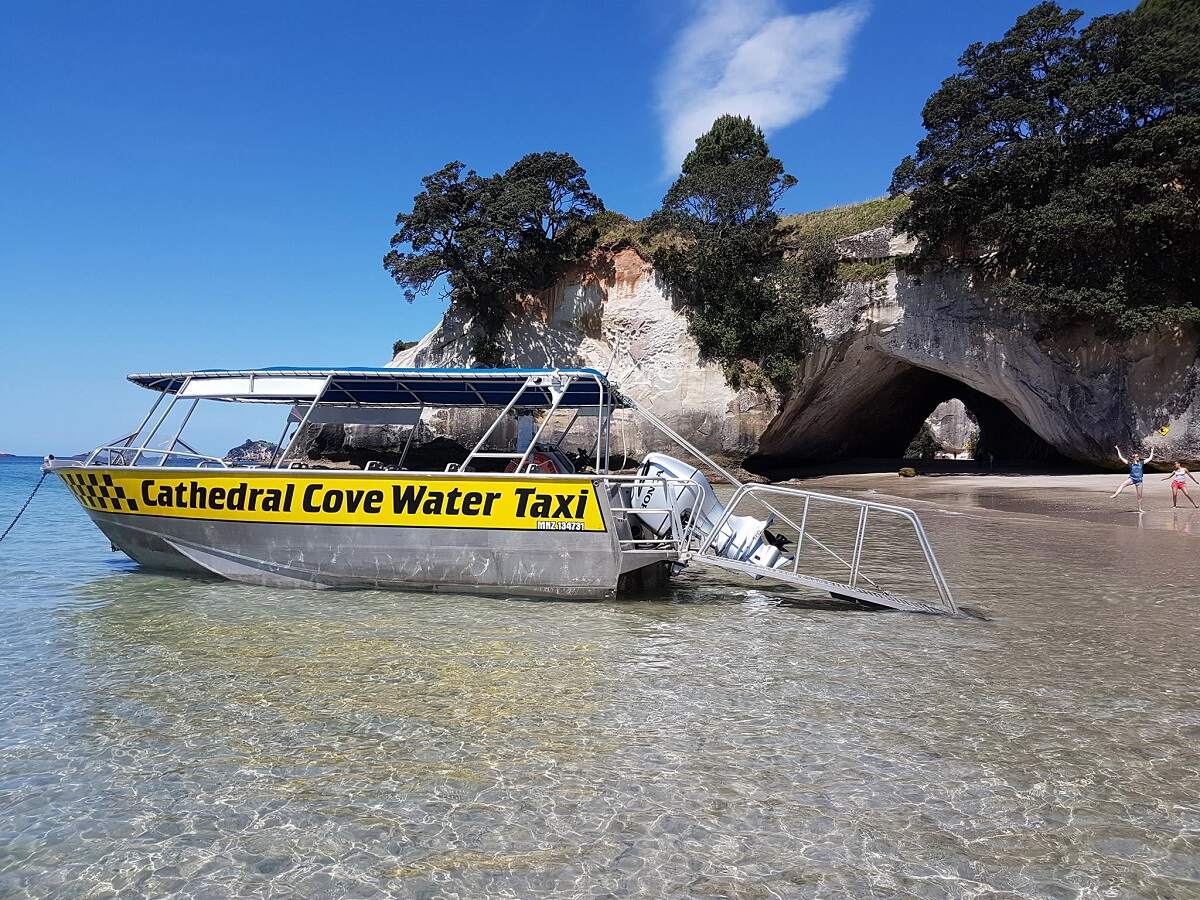 view of the water taxi boat in the water at Cathedral Cove