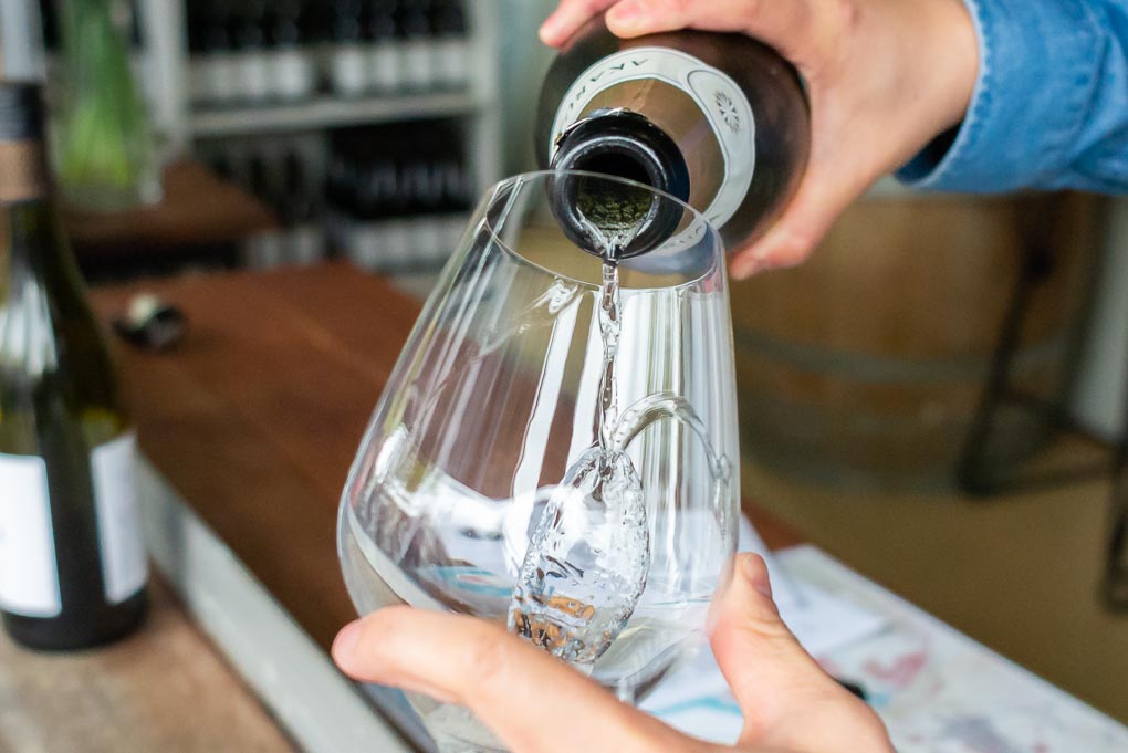 Pouring a glass of wine at the Akarua Wines Cellar door near Queenstown