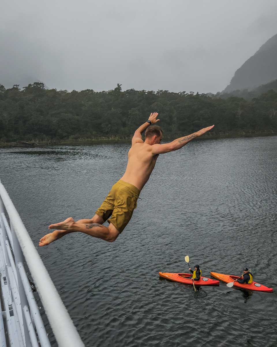 Daniel jumps off our boat on a Milford Sound cruise in New Zealand