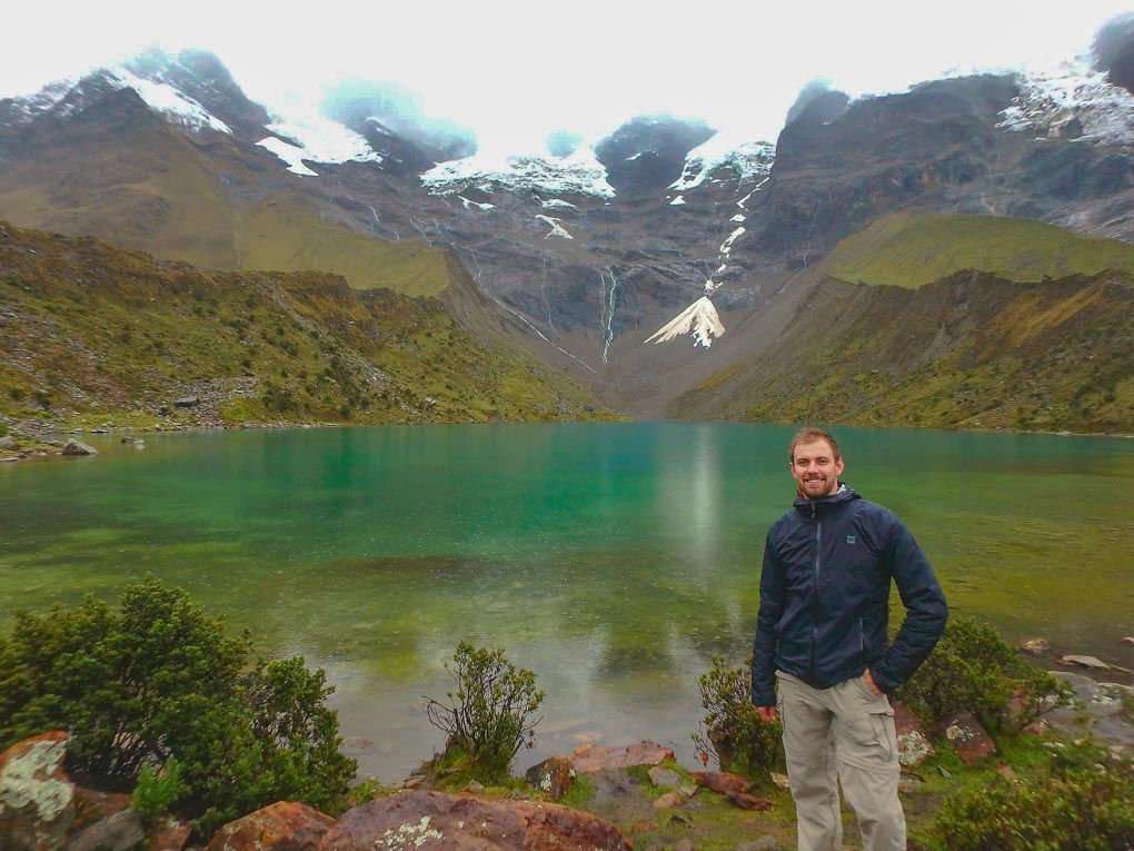 Standing at a lake on the Salkantay Trek