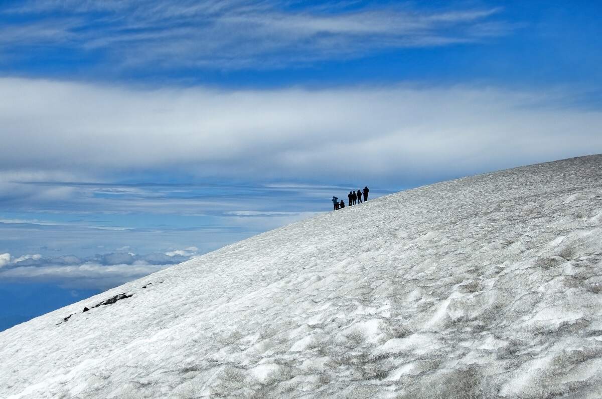 people hiking in the snow on Villarrica Volcano in Chile