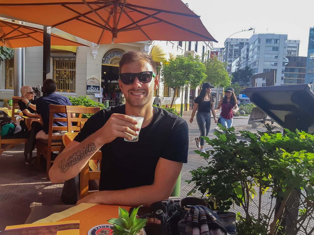 daniel drinking a pisco sour in peru