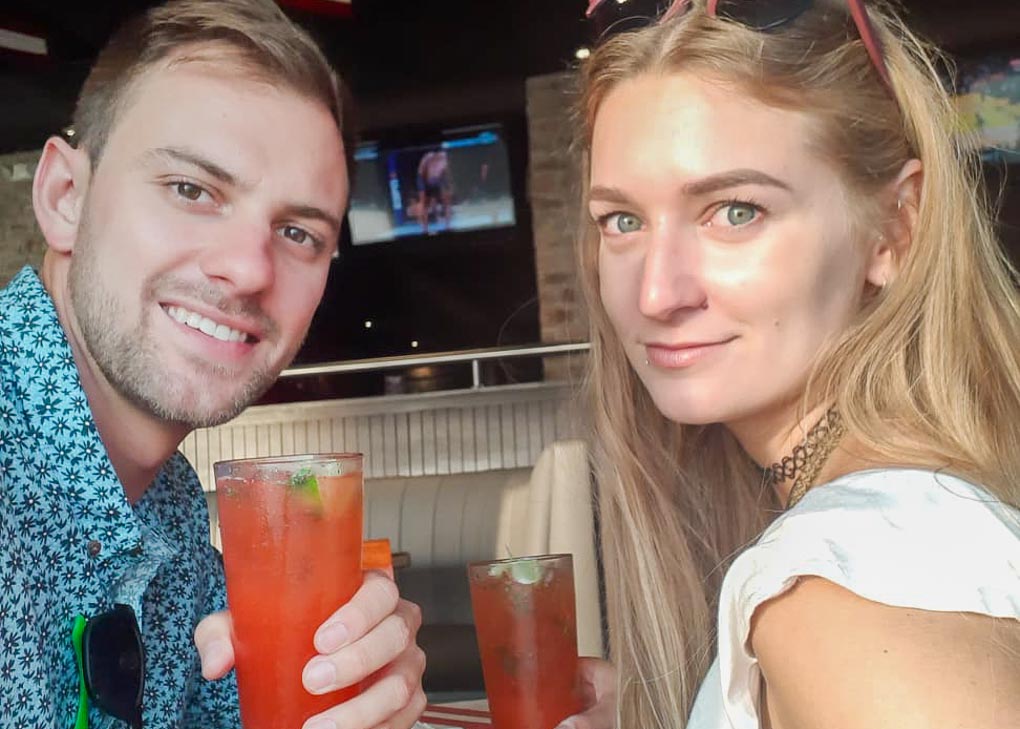Daniel and Bailey enjoy a drink on a sunny day