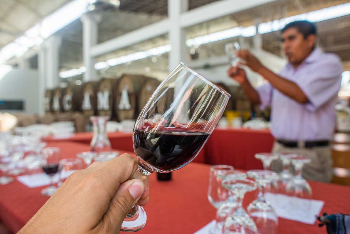 A glass of Pisco wine on a tour from Huacachina