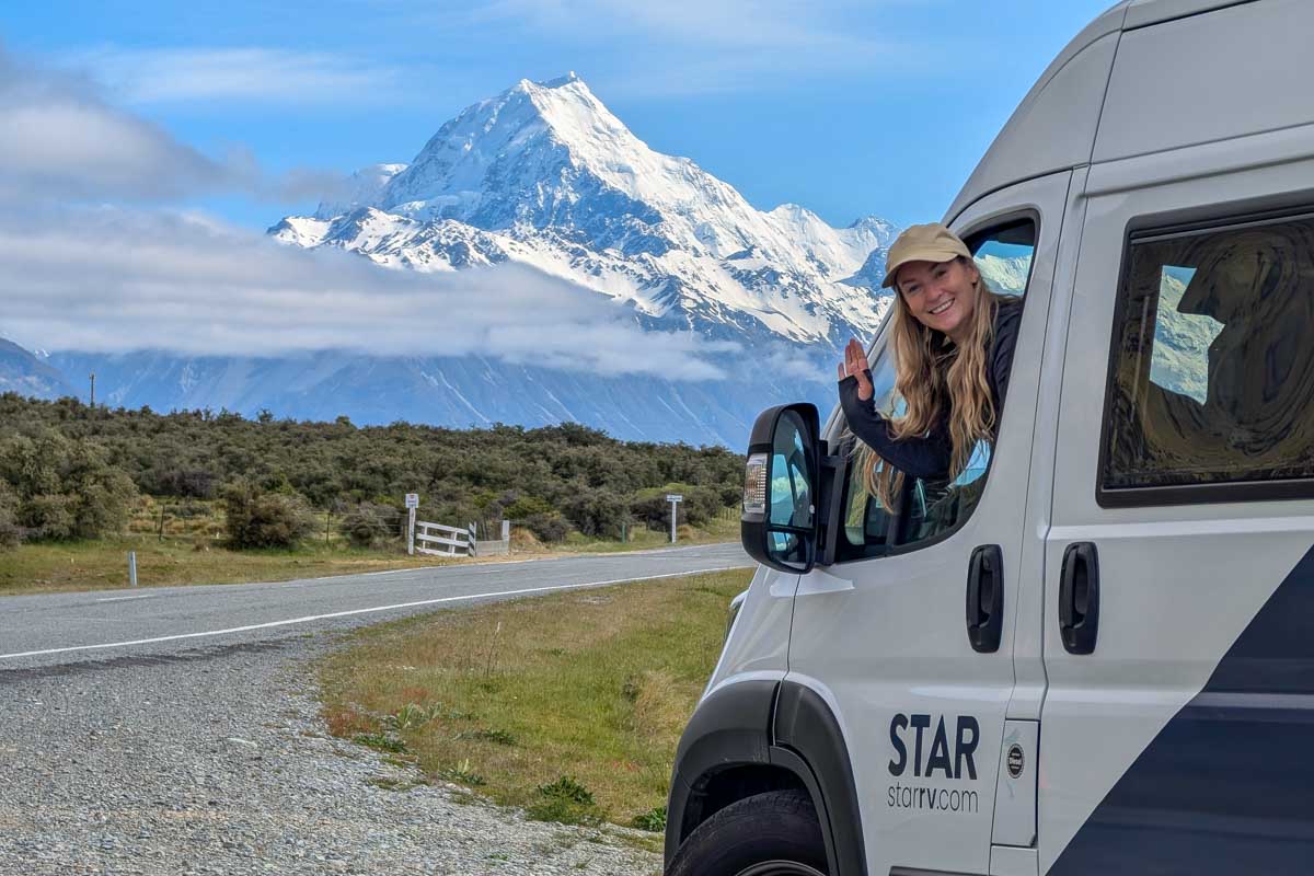 Bailey-sits-in-a-Star-RV-campervan-in-New-Zealand-with-mountain-in-the-background