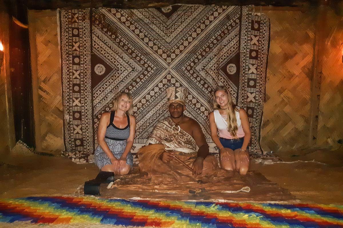 two women pose with the village chief at the Fiji Culture Village
