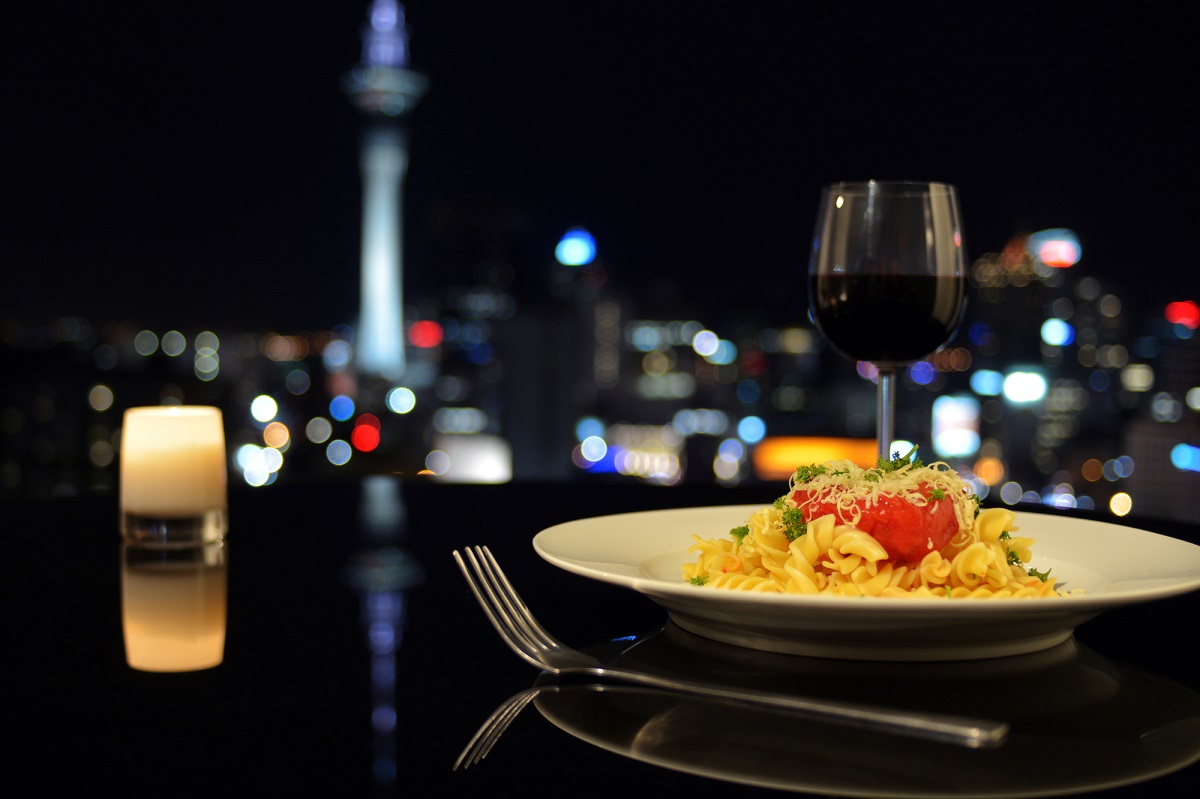 plate of pasta at a restaurant with a view of the Skytower in Auckland