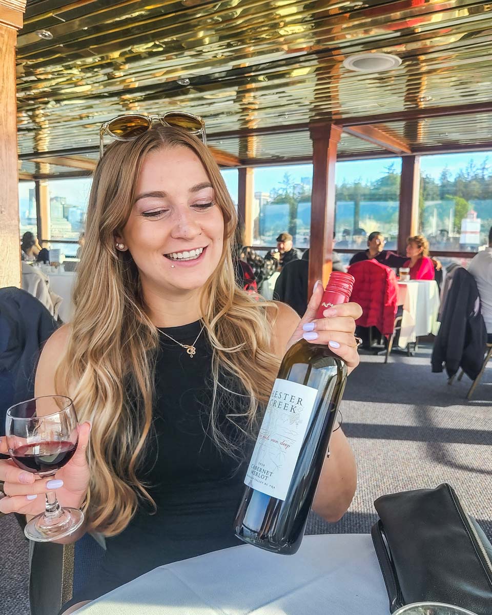 Bailey with a bottle of wine oin a sunset cruise in Vancouver, BC