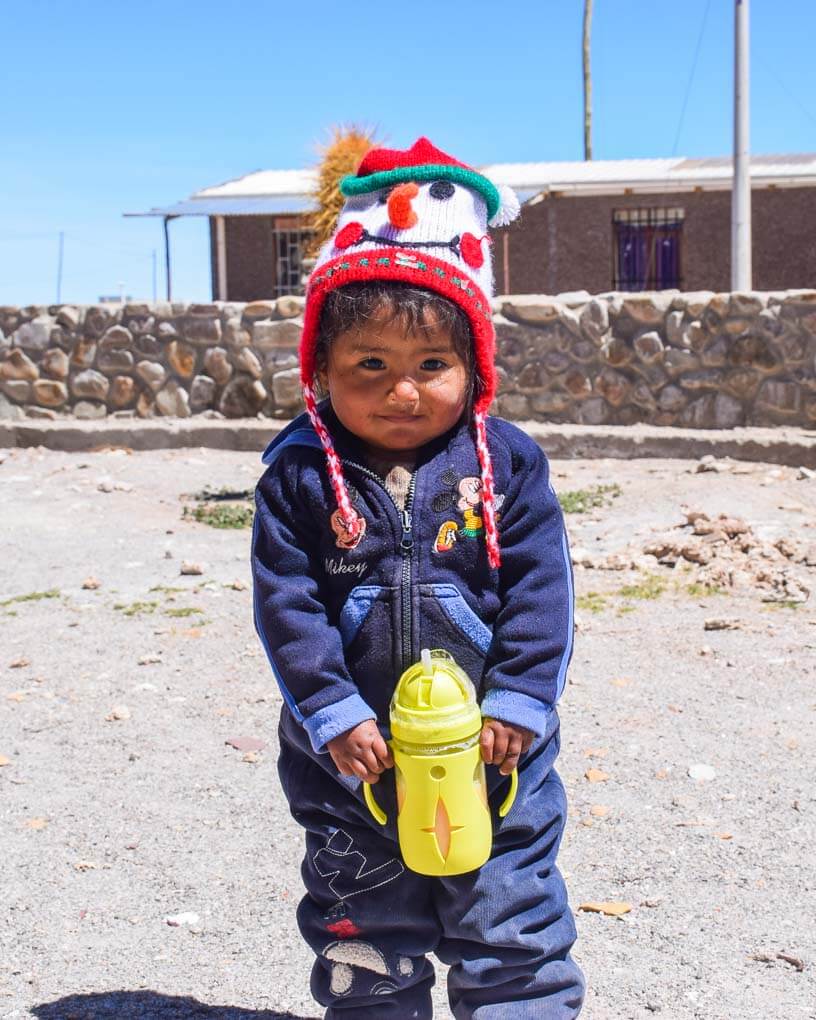 A young kid rugged up on the salt flats in Bolivia