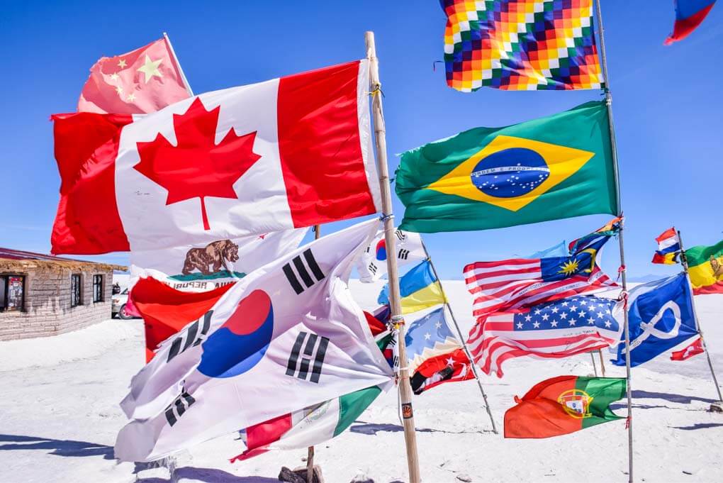 Flags from the countries who drive the Dakar Rally on the salt flats of Bolivia