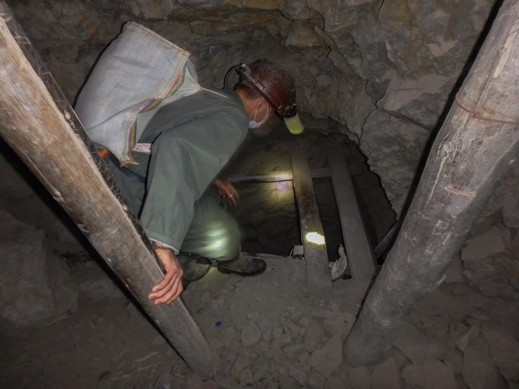 Daniel climbs down a ladder in the mines in Potosi, Bolivia