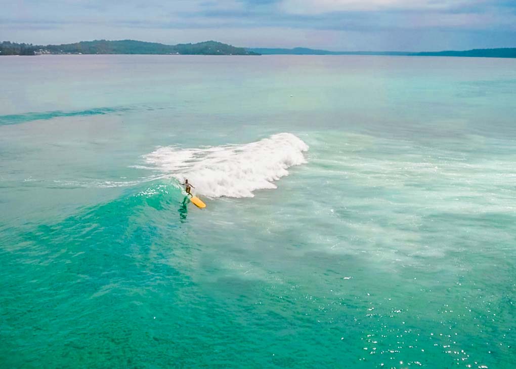 Drone shot of someone surfing in Bocas del Toro, Panama