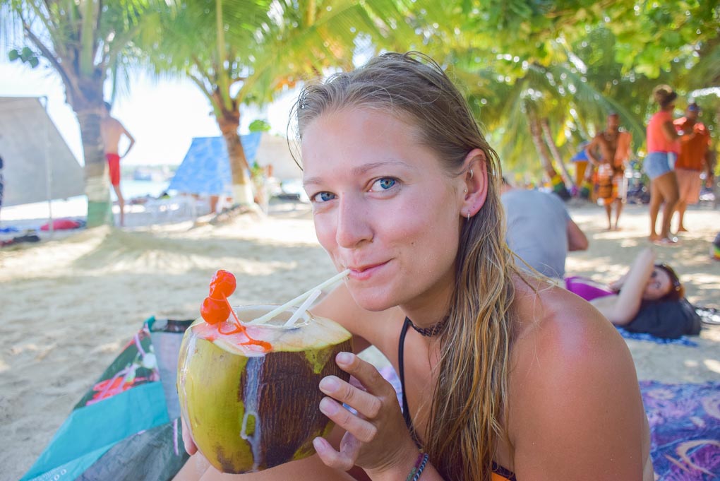 Bailey drinking coconut water on the beach