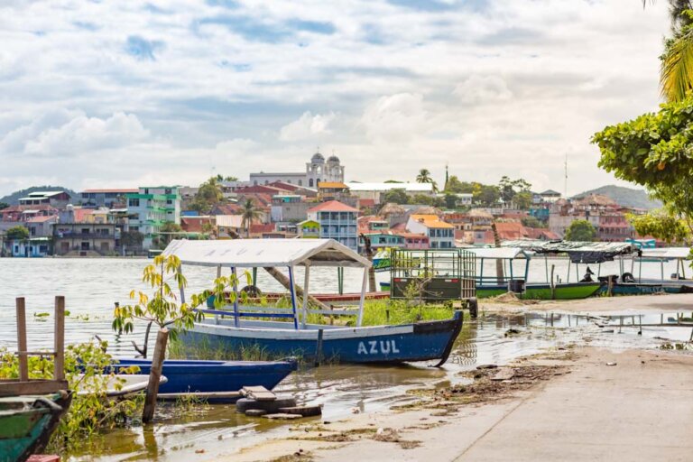 A view of a boat and the town of Flores in Guatemala