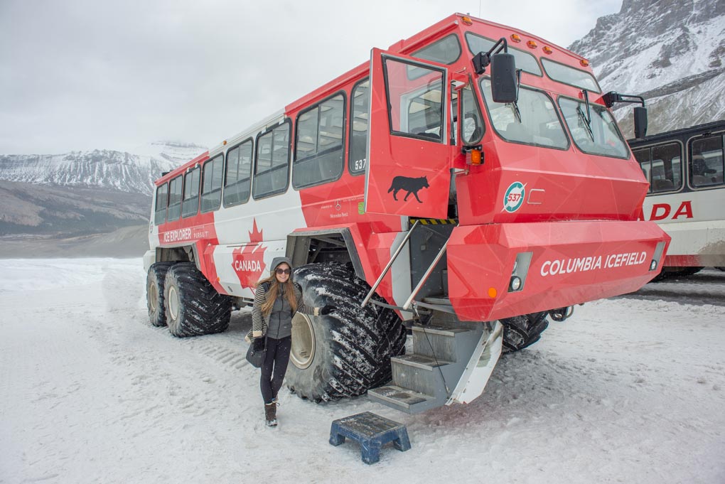 Bailey stands next to the 4wd bus on the Athabasca Glacier Icewalk tour