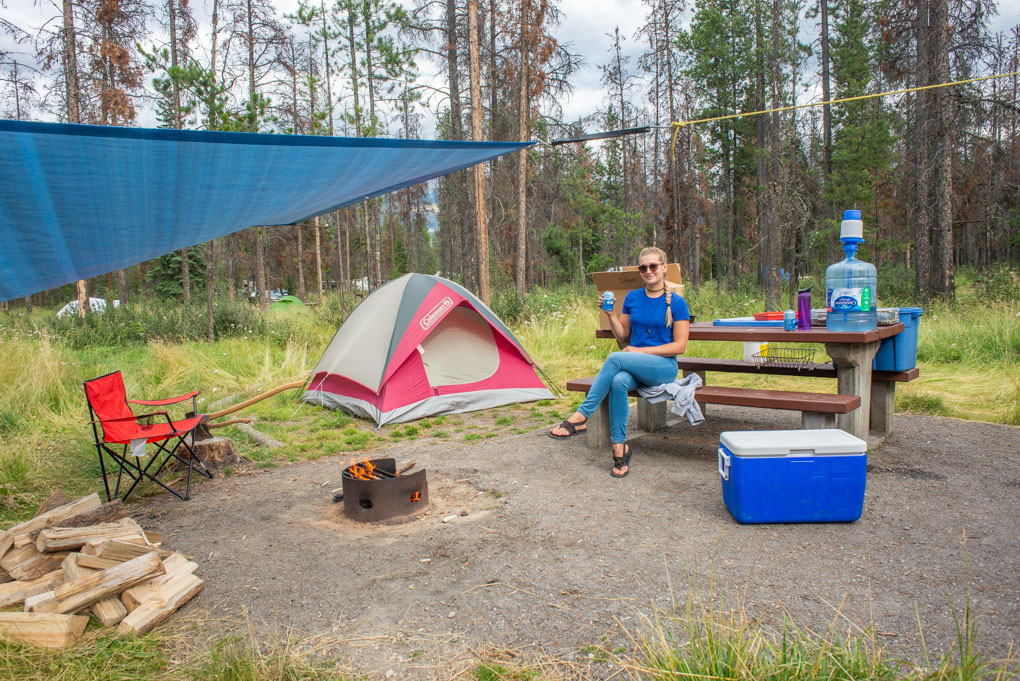 Bailey sits on the bench at our camsite in jasper while the fire burns