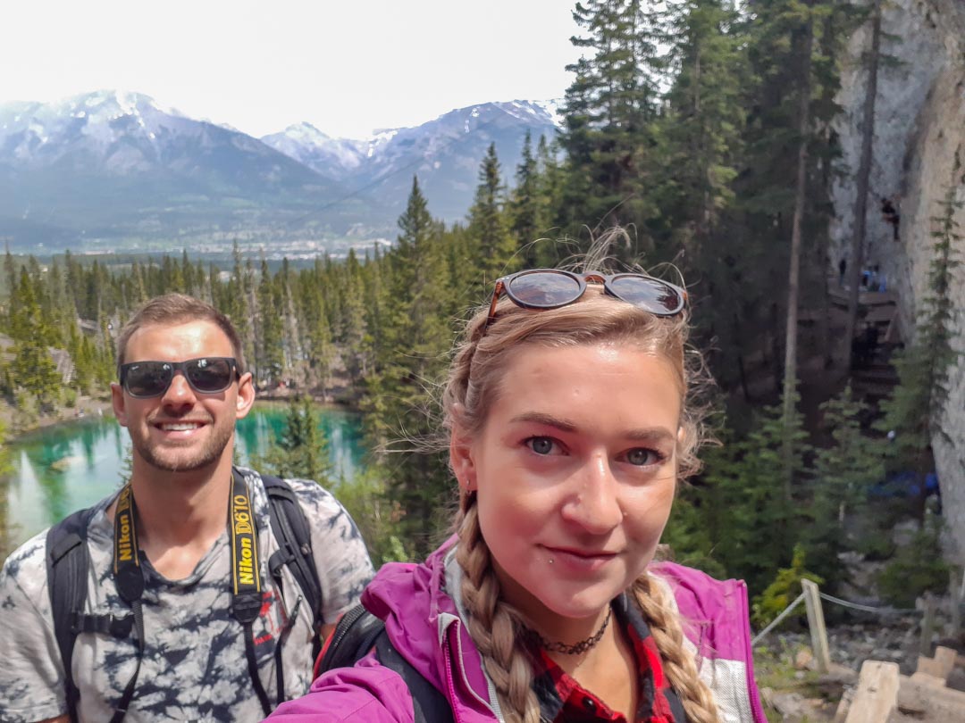 Bailey and Daniel from Destinationless Travel take a selfie at Grassi Lakes, Canmore