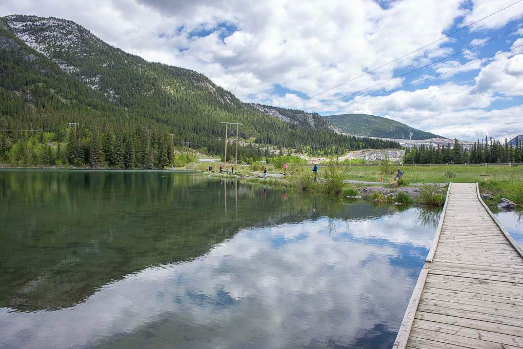 A reflection shot at Grotto Lake while people fish