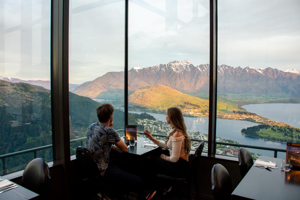 A couple enjoy a honeymoon dinner at the Skyline restaurant in Queenstown New Zealand
