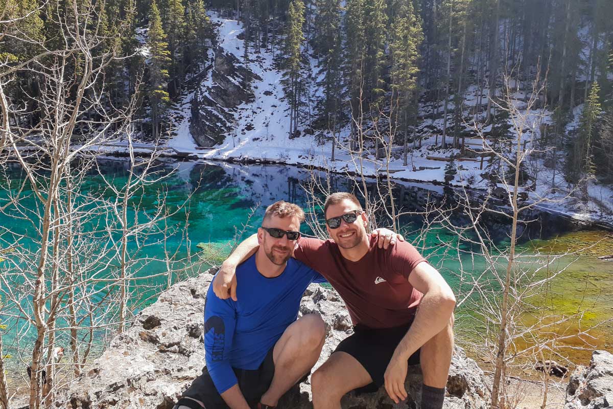 Daniel and a friend pose for a photo at Grassi Lakes at the end of winter