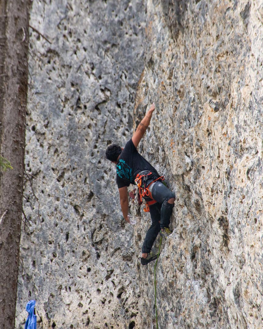 A man climbs a rockface at Grassi Lakes, Canmore