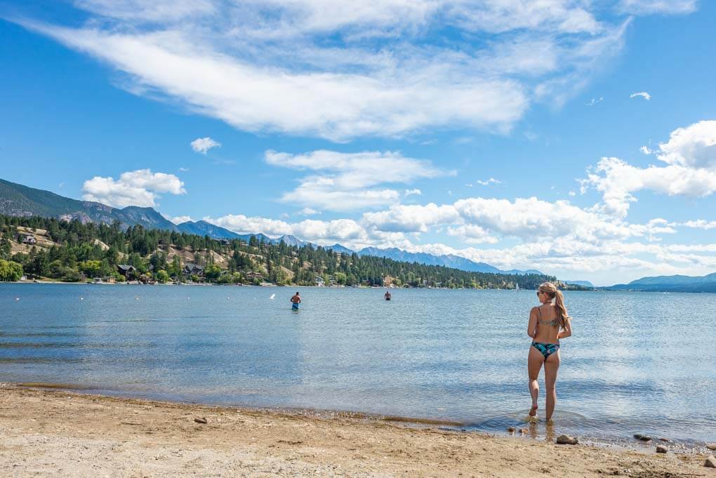 A lady walks into the water at James Chabot Provincial Park in Invermere, BC
