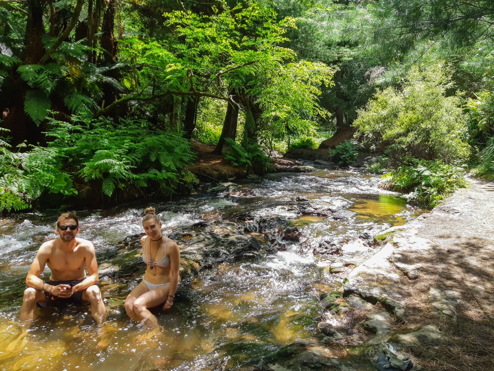 A coupe relax in Kerosene Creek on the Thermal Explorer Highway in New Zealand