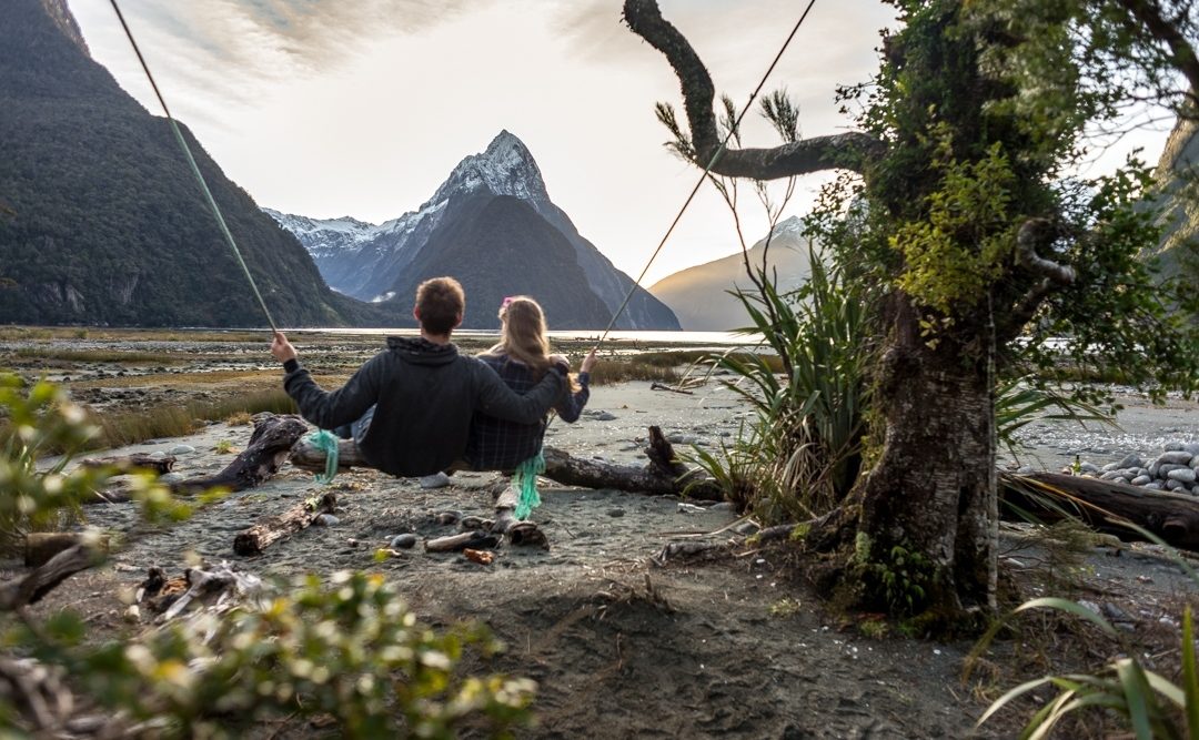 A couple on the milford sound swing